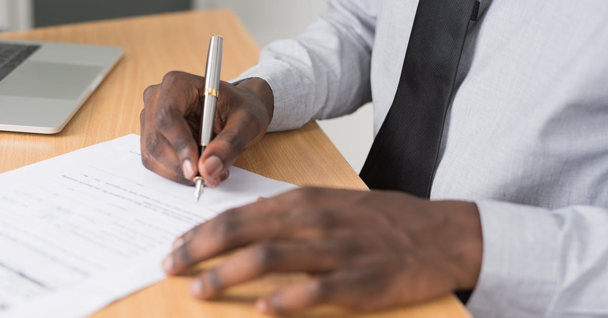 Paperwork and pen on a desk representing therapy intake forms